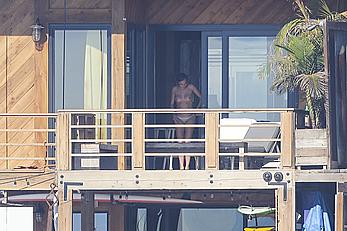 Cara Delevingne sunbathing topless on a balcony in Malibu