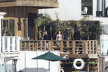 Cara Delevingne sunbathing topless on a balcony in Malibu