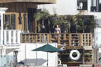 Cara Delevingne sunbathing topless on a balcony in Malibu