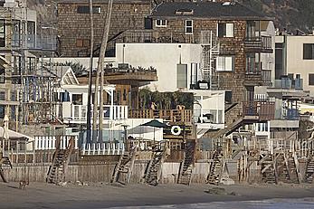 Cara Delevingne sunbathing topless on a balcony in Malibu