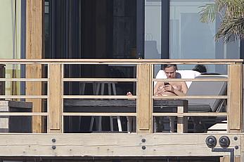 Cara Delevingne sunbathing topless on a balcony in Malibu