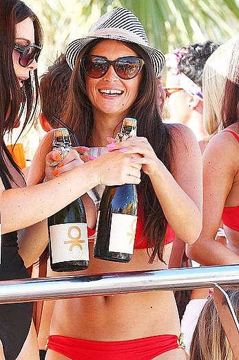 Casey Batchelor in red bikini poolside with friends in Ibiza