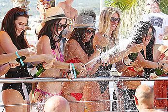 Casey Batchelor in red bikini poolside with friends in Ibiza