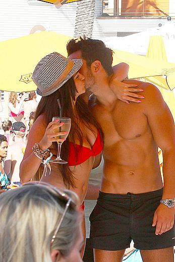 Casey Batchelor in red bikini poolside with friends in Ibiza