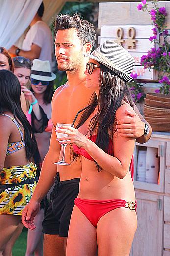 Casey Batchelor in red bikini poolside with friends in Ibiza