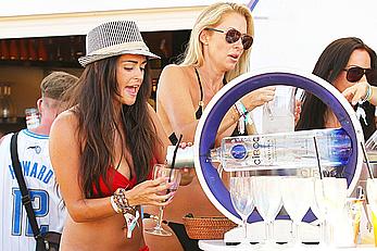 Casey Batchelor in red bikini poolside with friends in Ibiza