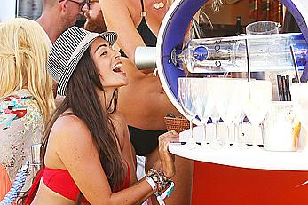 Casey Batchelor in red bikini poolside with friends in Ibiza