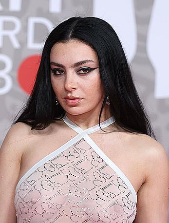 Charli XCX braless in see through tight dress at The BRIT Awards 2023 in London