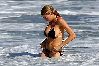 Charlotte McKinney side of boob and round ass in bikini on a beach in Malibu