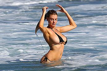 Charlotte McKinney side of boob and round ass in bikini on a beach in Malibu