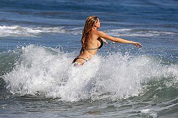 Charlotte McKinney side of boob and round ass in bikini on a beach in Malibu