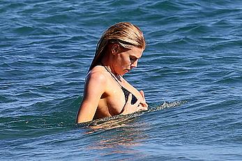 Charlotte McKinney side of boob and round ass in bikini on a beach in Malibu