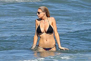 Charlotte McKinney side of boob and round ass in bikini on a beach in Malibu