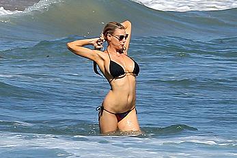 Charlotte McKinney side of boob and round ass in bikini on a beach in Malibu