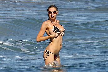 Charlotte McKinney side of boob and round ass in bikini on a beach in Malibu