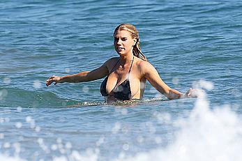 Charlotte McKinney side of boob and round ass in bikini on a beach in Malibu