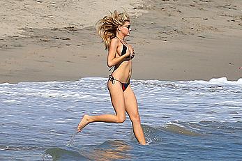 Charlotte McKinney side of boob and round ass in bikini on a beach in Malibu