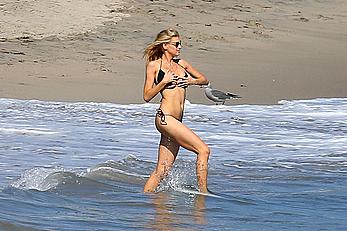 Charlotte McKinney side of boob and round ass in bikini on a beach in Malibu