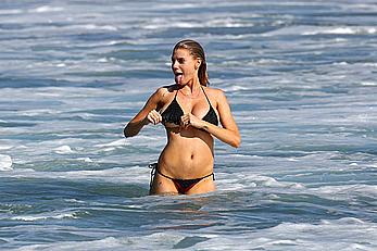 Charlotte McKinney side of boob and round ass in bikini on a beach in Malibu