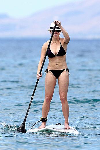 Chelsea Handler shows deep cleavage in black bikini at a beach in Hawaii