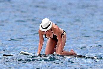 Chelsea Handler shows deep cleavage in black bikini at a beach in Hawaii