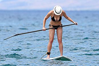 Chelsea Handler shows deep cleavage in black bikini at a beach in Hawaii