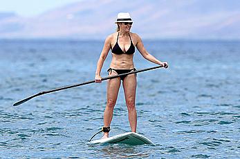 Chelsea Handler shows deep cleavage in black bikini at a beach in Hawaii