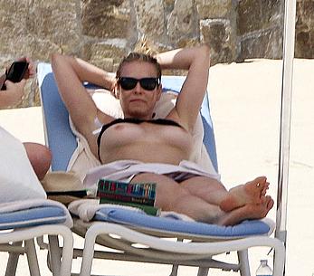 Chelsea Handler sunbathing topless at a beach in Mexico