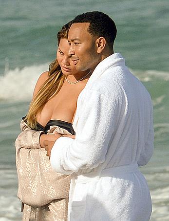 Chrissy Teigen topless during photoshoot at Miami Beach