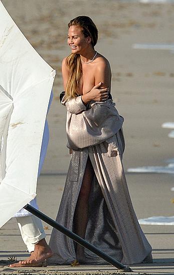 Chrissy Teigen topless during photoshoot at Miami Beach