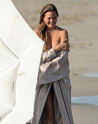 Chrissy Teigen topless during photoshoot at Miami Beach