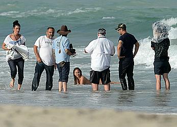 Chrissy Teigen topless during photoshoot at Miami Beach