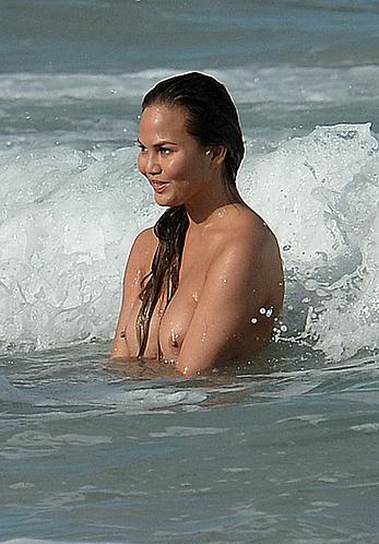 Chrissy Teigen topless during photoshoot at Miami Beach