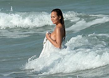 Chrissy Teigen topless during photoshoot at Miami Beach