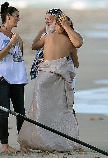 Chrissy Teigen topless during photoshoot at Miami Beach