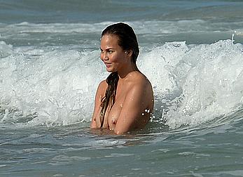 Chrissy Teigen topless during photoshoot at Miami Beach