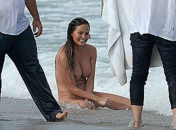 Chrissy Teigen topless during photoshoot at Miami Beach