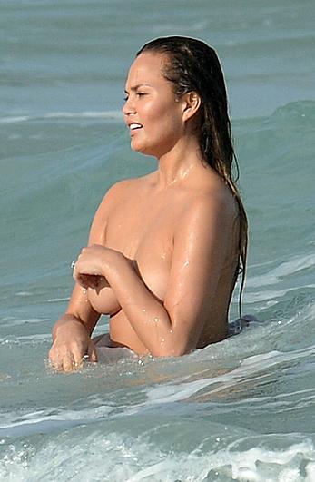 Chrissy Teigen topless during photoshoot at Miami Beach