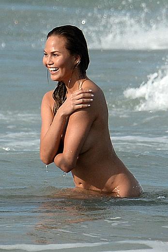 Chrissy Teigen topless during photoshoot at Miami Beach