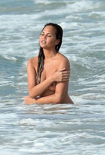 Chrissy Teigen topless during photoshoot at Miami Beach