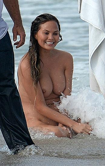 Chrissy Teigen topless during photoshoot at Miami Beach