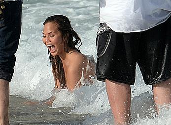 Chrissy Teigen topless during photoshoot at Miami Beach