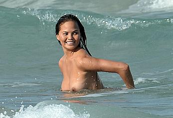 Chrissy Teigen topless during photoshoot at Miami Beach