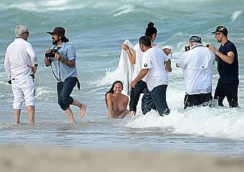 Chrissy Teigen topless during photoshoot at Miami Beach