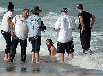 Chrissy Teigen topless during photoshoot at Miami Beach