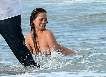 Chrissy Teigen topless during photoshoot at Miami Beach