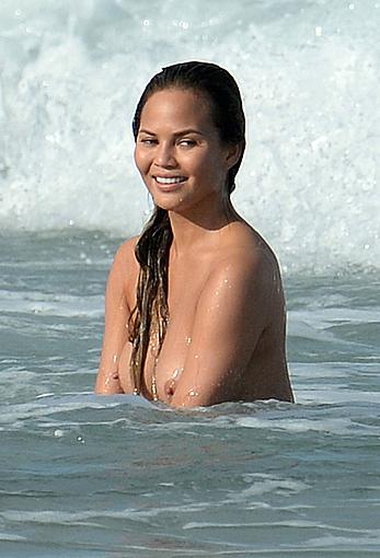 Chrissy Teigen topless during photoshoot at Miami Beach