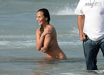 Chrissy Teigen topless during photoshoot at Miami Beach