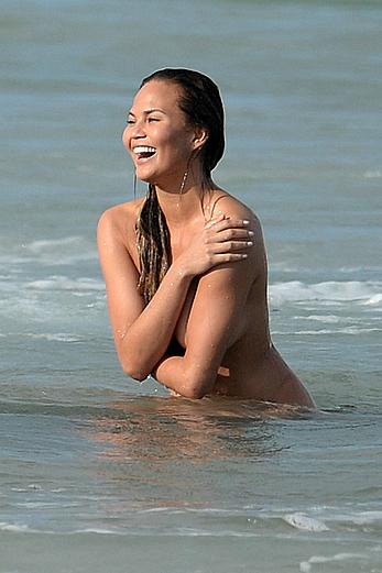 Chrissy Teigen topless during photoshoot at Miami Beach