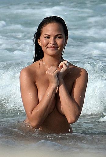 Chrissy Teigen topless during photoshoot at Miami Beach